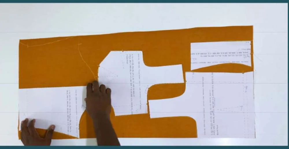 Printed pattern on fabric — piece name and measurements right on the paper.